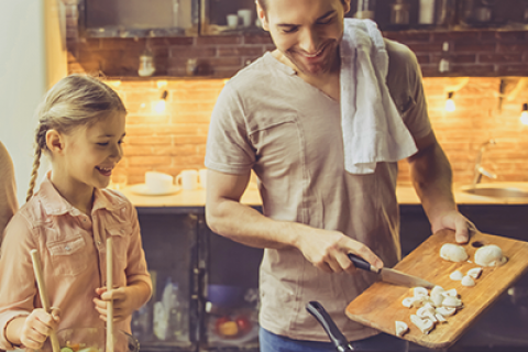 Man and Daughter Cook in Kitchen