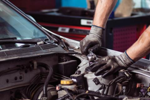 Under the hood of a car, making repairs